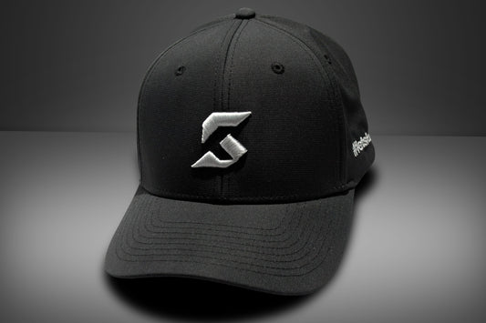 Black cap with a white konnek sports logo on a gray background