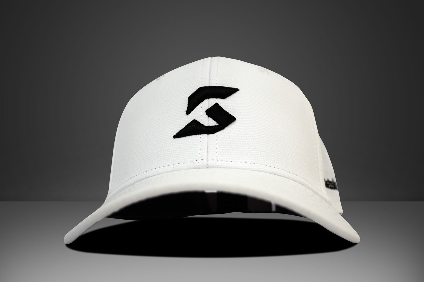 White cap with a black konne ksports logo on a gray background