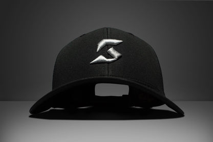 Black cap with a white konnek sports logo on a dark background