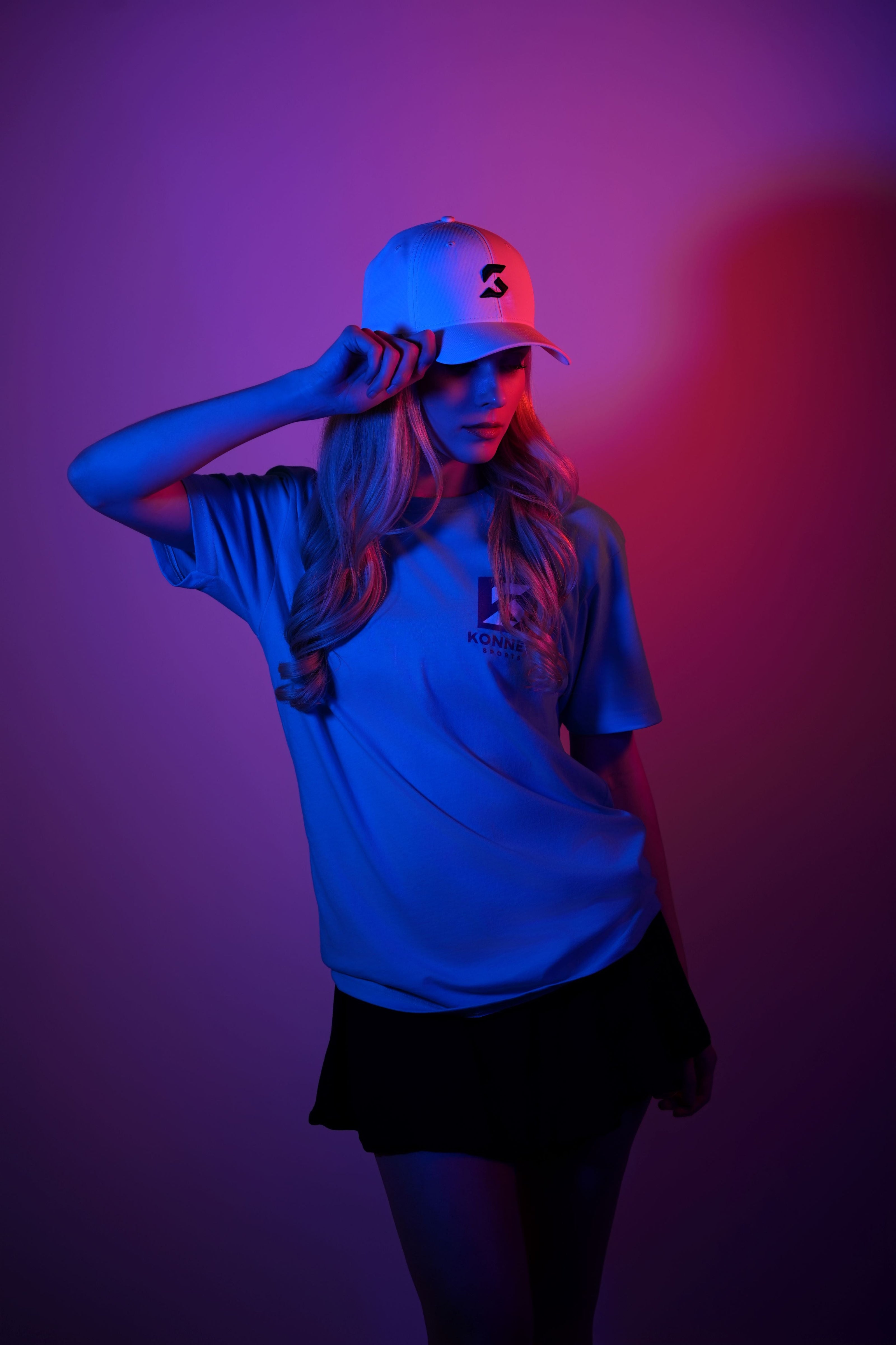 Female wearing a cap and white shirt with a blurred background